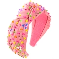 Close-up of pink knotted headband featuring vibrant sequins, beads, and metallic tube charms - Glitter Pink