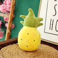 Cute pineapple plush toy with yellow quilted fabric and green leaves on a woven mat - Pineapple