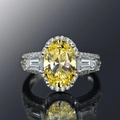 Macro view of luxury oval yellow gemstone ring with diamond halo on white gold band - US 10 / White and Yellow Zirconia