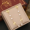 Detail of gold layered necklace featuring heart clover charms and white pearls on jewelry box - Hollow Clover Pearl Chain Style (4#)