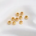 Polierte 14K Gold-Rondellperlen für DIY-Schmuck auf weißem Stoffhintergrund - AD 6,0mm Dicke 3,8mm Loch 3,2mm