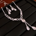 Silver teardrop necklace and earrings set with sparkling cubic zirconia on black background - Y-Shape Water Drop Pendant Diamond Necklace / Silver