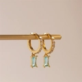 Detail of gold huggie hoop earrings with rectangular light blue zircon drops and white stones - Light Blue