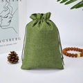 Green linen drawstring bag for jewelry and gift packaging shown with rustic props - Army Green