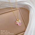 Detail of golden butterfly pendant with pink and clear stones on a display box - Pink Butterfly Style (D453)