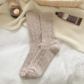 Beige cable knit wool blend socks laid on white bedding for a cozy winter style - One Size / 453 Khaki