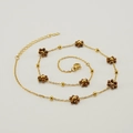 Gold stainless steel necklace featuring brown flower charms and delicate golden round beads - Necklace / Bronze