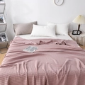 Cozy pink waffle cotton blanket draped on a bed within a minimalist bedroom setting - 200*230cm / Dusty Pink