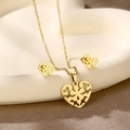 Detailed view of gold-plated hollow heart necklace and stud earrings set on a white tray - Heart Hollow (TZ-424)