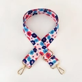 Detail of adjustable floral strap with red and blue flowers and golden metal buckles - Pink Floral / Gold Buckle