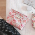 Detailed macro view of floral canvas makeup bag with Time To Party embroidered label - Pink