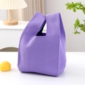 Macro shot of purple knitted handbag showing detailed texture in cozy home setting - Purple