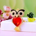 Gold owl keychain featuring a large red heart gemstone and crystal accents - A430 Owl G Red
