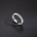 Detailed top view of silver hollow floral ring with zircon pavé on black texture - Heart Hollow Zirconia Style (Style 2)