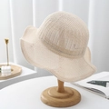 Detailed knit texture of beige sun hat with hollow pattern and wavy brim on wood stand - Adult/55-57cm (Adjustable) / Beige