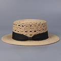 Close-up of natural raffia boater hat featuring a black grosgrain ribbon bow decoration - M (56-58cm) / Black Strap