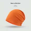 Minimalist orange knitted slouchy beanie for women featuring a soft, flexible texture - Solid Minimalist Style / Orange