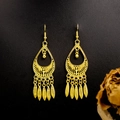 Detail of ethnic golden peacock earrings featuring leaf tassels on a black texture background - E5765-17 Inverted Teardrop Ethnic Hollow
