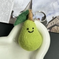 Handmade green wool felt pear keychain with smiling face and metallic ring - No Pressure Pear