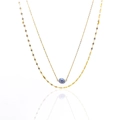 Detail of double-layer gold necklace featuring a blue stone pendant and olive leaf chain - Blue Aventurine
