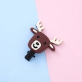 Cartoon reindeer hair clip made of soft silicone on a blue and pink background - Elk