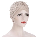 Detail of beige pleated turban with white pearls and silver beads on elastic fabric - Beige