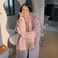 Pink plaid mohair scarf with tassels worn by a model in a cozy, warm cafe setting - Pink