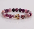 Detailed close-up of 8mm faceted stone beads and a gold crown charm with crystals - Pink Purple Marble