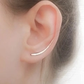 Minimalist silver curved ear crawler earring shown on ear in a close-up lifestyle shot - White Gold