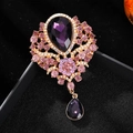 Elegant vintage gold brooch with large purple pear-shaped crystal and pink accents - Purple