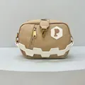 Macro view of khaki crossbody bag with textured leather, golden zipper and P logo - Khaki