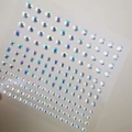 Detailed view of iridescent butterfly facial crystals and mixed size adhesive makeup gems - AB Iridescent Loose Jewels