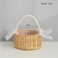 Detail of hand-woven wicker flower basket with pearl handle and white ribbon bows - Full Pearl Handle Style / Large