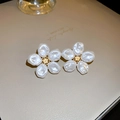 Macro shot of elegant floral earrings with white pearl petals and golden hollow centers - 925 Silver Pin Wrinkled Pearl Flower Style