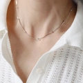 Elegant silver snake chain necklace with small round beads on a minimalist background - Beaded Snake Bone Chain Necklace / Steel