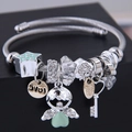 Silver beaded angel bracelet with green heart and star charms on black display box - Green