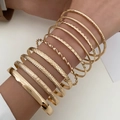 Set of 11 golden alloy bangles featuring hammered, twisted, and braided textures for layering - Gold 11-Piece Multi-texture Closed Loops (11760)