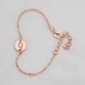 Rose gold chain bracelet featuring a hollow round pendant with the letter Q and lobster clasp - Rose Gold Q