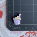Close-up of a miniature purple beach bucket with pink shovel and yellow sand on a scale mat - Purple Sand Shovel and Bucket