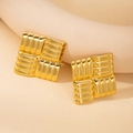 Macro shot of gold square stud earrings with unique 3D wavy texture and metallic finish - Square Checkered / Gold
