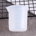 Close-up of translucent 100ml silicone measuring cup with clear scale markings for resin DIY - 56067 Unpackaged 100ml Cup