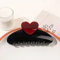 Detail of a large black resin hair claw clip with a red heart on a decorative tray - Heart Semicircle / Black