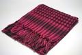 Detailed view of pink and black Keffiyeh desert scarf with traditional fringe tassels - Rose Red