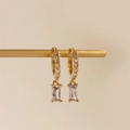 Close-up of gold hoop earrings featuring white zircons and rectangular lilac gemstone pendants - Light Purple