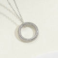 Detail of silver paved circle pendant with clear zircons on delicate cable chain - Platinum Color