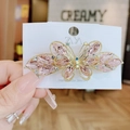 Pince à cheveux papillon en cristal rose avec cadre doré sur une carte - Rose