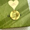 Detail of green embossed gift box with gold Feliz Cumpleanos seal and floral texture - Spanish Birthday Style 2