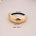 Golden alloy bow hair tie with dimensions 5.5cm by 2.8cm and 9g weight on beige background - #15-Minimalist Arc