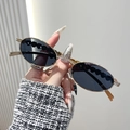 Oval gold metal sunglasses featuring diamond accents and wave-patterned dark lenses - Gold Frame White Rhinestone Grey Lens