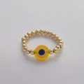 Detail of handmade 18K gold plated beaded ring with a yellow evil eye pendant charm - Size 7 (Elastic) / Yellow